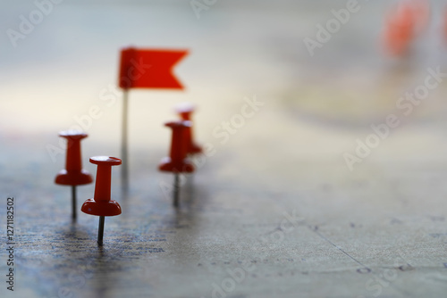 Close-Up of Red Push Pins and Flags on a Map Indicating Travel Destinations or Strategic Points photo