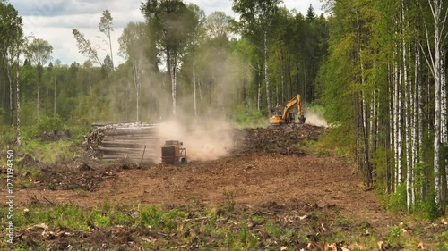 A mulcher shred organic material, leaves, branches, grass, or other plant debris, into smaller pieces. Construction of a road through the forest. Cutting and clearing of forest for road construction.