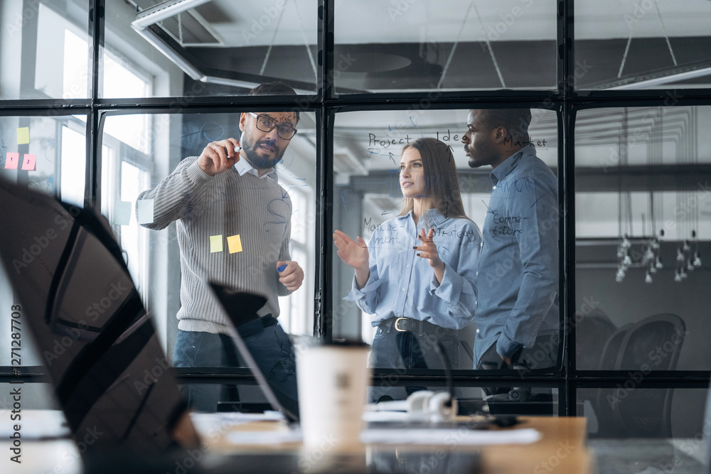 Fototapeta premium Tactics, planning the job. Professional workers are in the modern office together