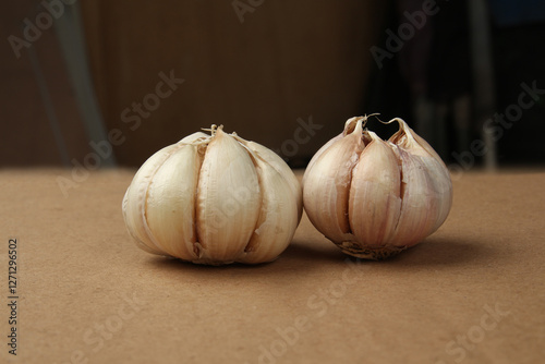 garlic still studio shot on a wooden table of background. Garlics clove
