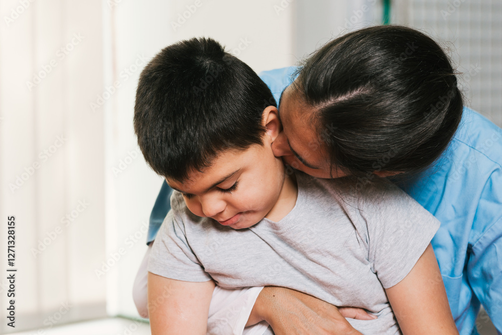 Nurse showing affection to child with disability during physiotherapy session Nurse showing affection to child with disability during physiotherapy session