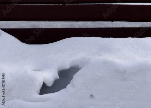 melted snow on a bench on the eve of spring in East Kazakhstan in the city of Ust Kamenogorsk photo