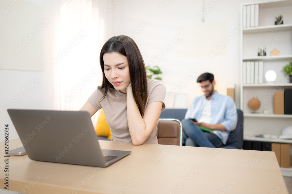 Portrait of a young freelancer smiling while working online via laptop at home with his boyfriend Portrait of a young freelancer smiling while working online via laptop at home with his boyfriend