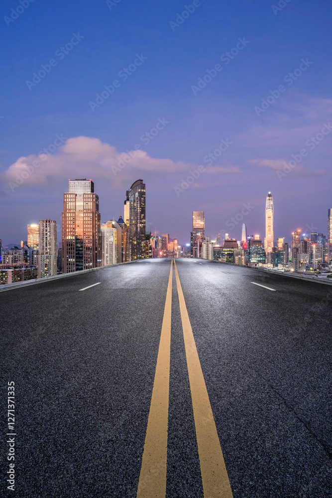 Straight asphalt road and city skyline at night in Shenzhen Straight asphalt road and city skyline at night in Shenzhen