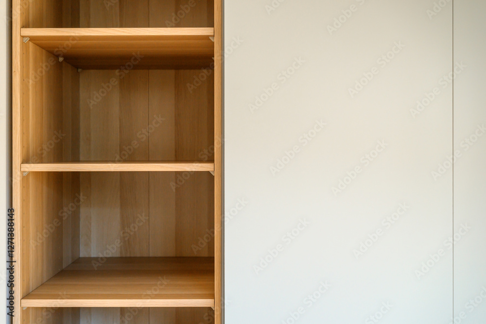 Fototapeta premium Simple minimalistic storage shelves made of wooden particleboard material, empty shelf as copy space