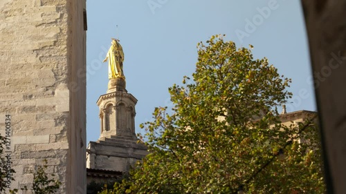 Back of the gilded statue of the Virgin Mary on placed atop of the bell tower of the Avignon Cathedral