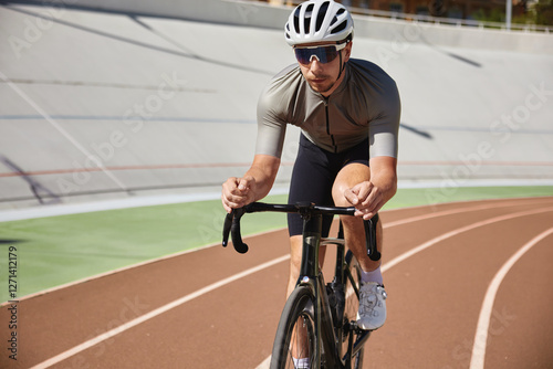 Bicyclist holding hands on steering wheel driving bike