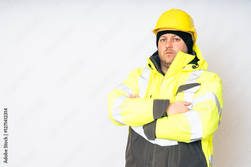 a man wearing a yellow working winter jacket and a yellow safety helmet . High quality photo a man wearing a yellow working winter jacket and a yellow safety helmet . High quality photo