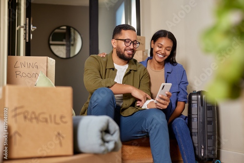 Middle eastern mid adult couple using phone after moving photo