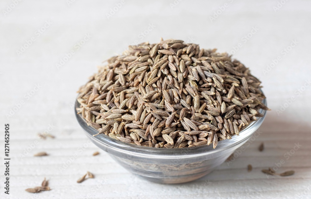 White Cumin Seeds in a Glass Bowl Isolated on White Background with Copy Space White Cumin Seeds in a Glass Bowl Isolated on White Background with Copy Space