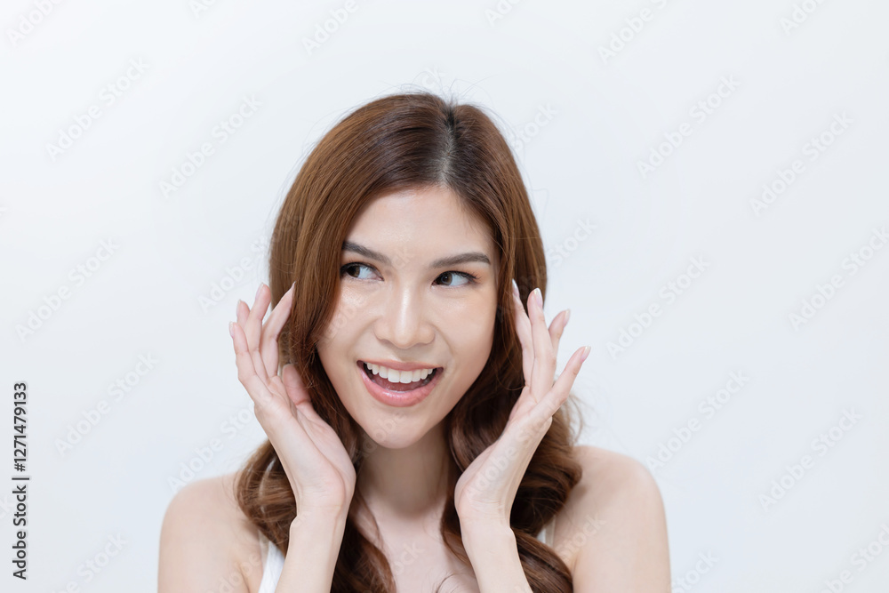 Asian woman applying skincare cream on her face Asian woman applying skincare cream on her face