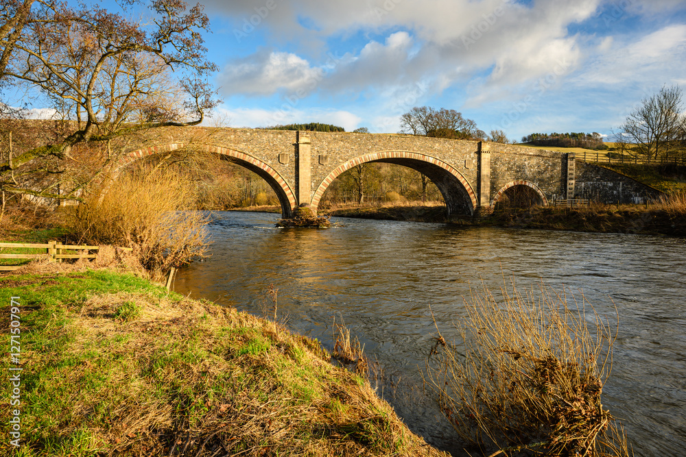 Old Tweed Bridge over River Tweed, which is 97 miles long from source to estuary and runs eastward in the Scottish Borders Old Tweed Bridge over River Tweed, which is 97 miles long from source to estuary and runs eastward in the Scottish Borders