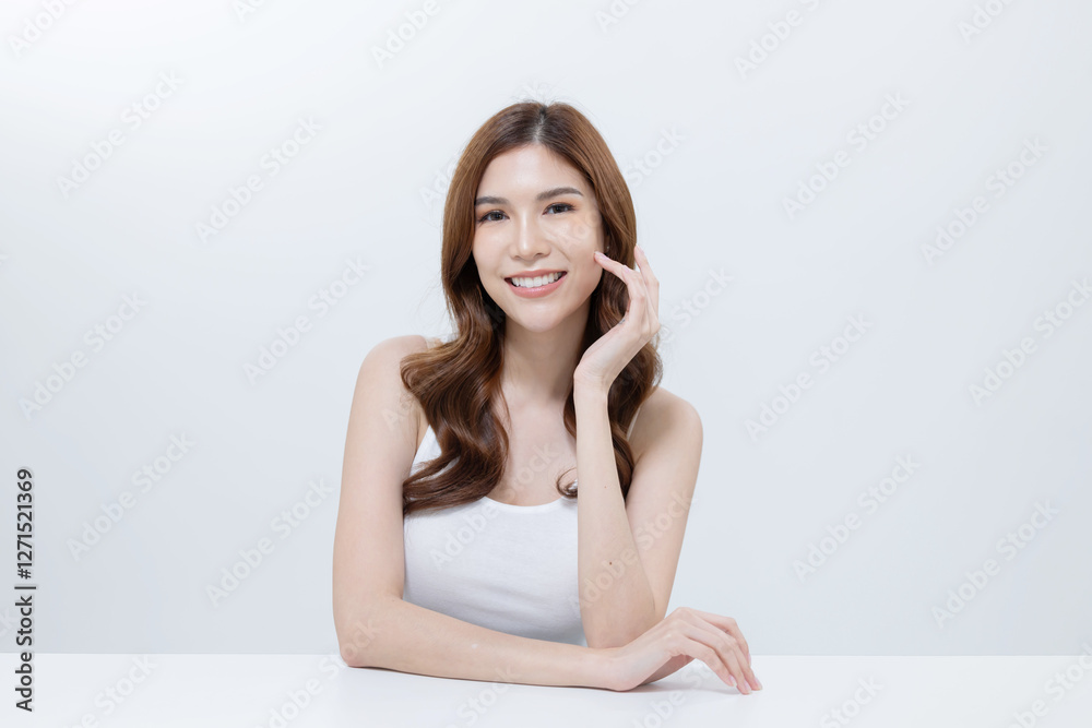Asian woman applying skincare cream on her face Asian woman applying skincare cream on her face
