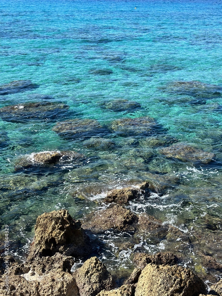 Crystal Clear Turquoise Sea with Rocky Seabed and Gentle Waves Crystal Clear Turquoise Sea with Rocky Seabed and Gentle Waves
