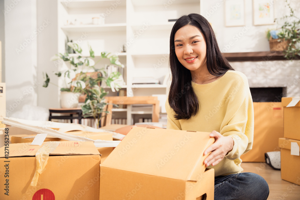 Asian smiling woman with cardboard boxes for moving to the new home. Concept of people moving house, buying property and decorating room Asian smiling woman with cardboard boxes for moving to the new home. Concept of people moving house, buying property and decorating room