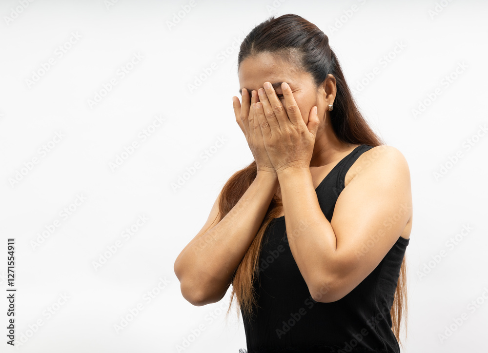 Woman Covering Her Face With Hands Expressing Emotions in a Calm Indoor Environment During the Day Woman Covering Her Face With Hands Expressing Emotions in a Calm Indoor Environment During the Day