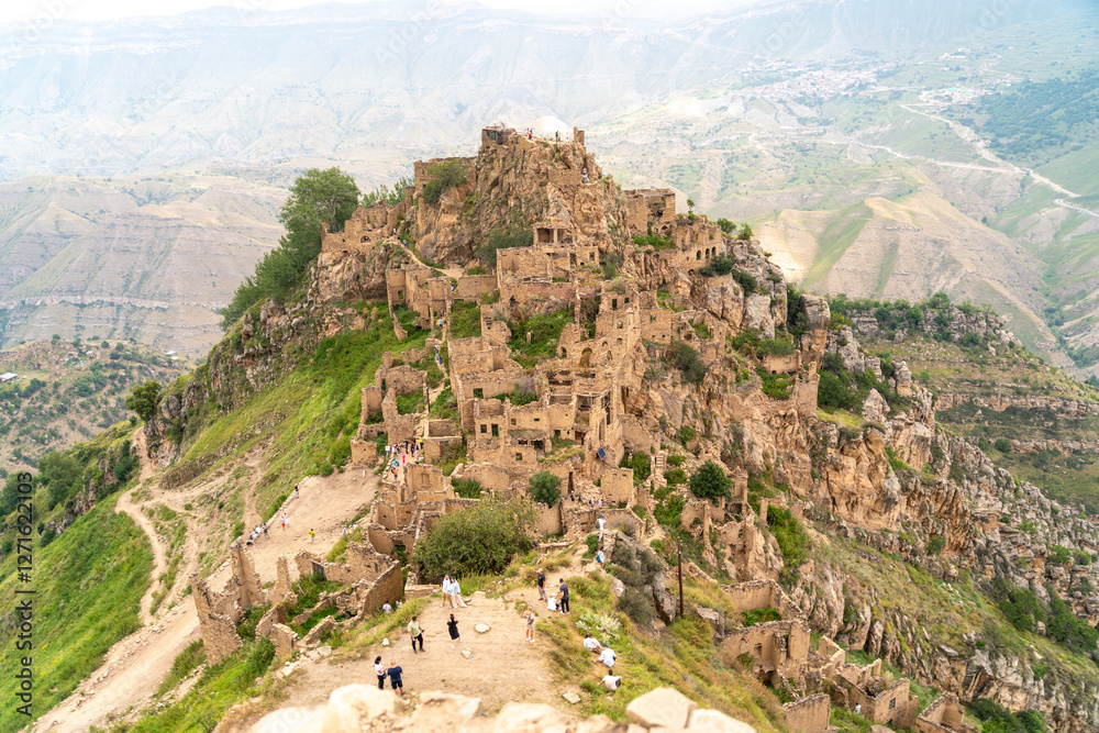 Obraz premium Dagestan Gamsutl. Ancient ghost town of Gamsutl old stone houses in abandoned Gamsutl mountain village in Dagestan, Abandoned etnic aul, summer landscape.