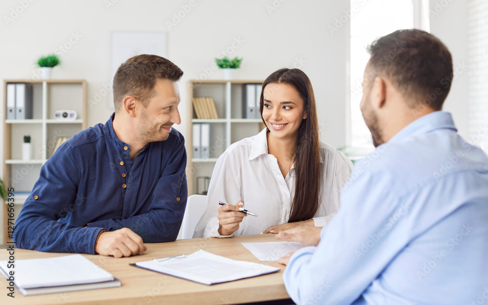 Happy smiling caucasian couple signing a contract reaching agreement with a man realtor or financial advisor sitting at desk on workplace. Insurance agent consulting clients in office. Happy smiling caucasian couple signing a contract reaching agreement with a man realtor or financial advisor sitting at desk on workplace. Insurance agent consulting clients in office.