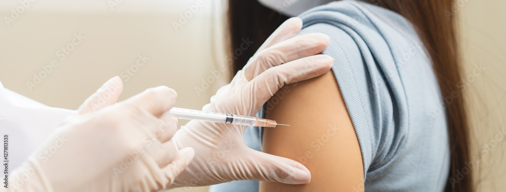 Fototapeta premium Health care, corona virus, hand of woman nurse, doctor giving syringe vaccine, injection dose on arm sick patient at clinic. Vaccination, immunization disease prevention against flu pandemic influenza