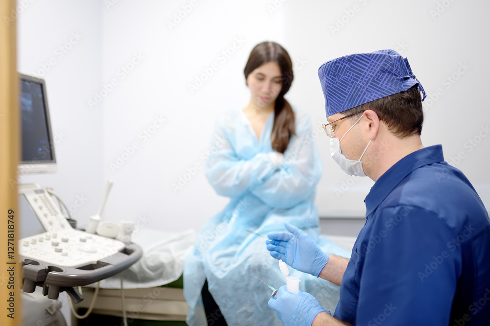 Obraz premium Mammalogist doctor is preparing to examine woman breasts and lymph nodes using ultrasound for diagnosis of breast cancer during appointment