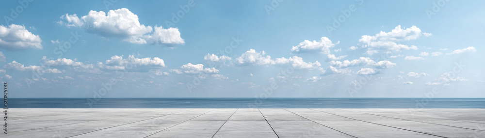 vast concrete plain stretches towards serene ocean under clear blue sky dotted with fluffy clouds, creating tranquil and expansive scene vast concrete plain stretches towards serene ocean under clear blue sky dotted with fluffy clouds, creating tranquil and expansive scene