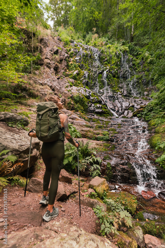 Active Woman Hiking in Mountain Forest with Waterfall