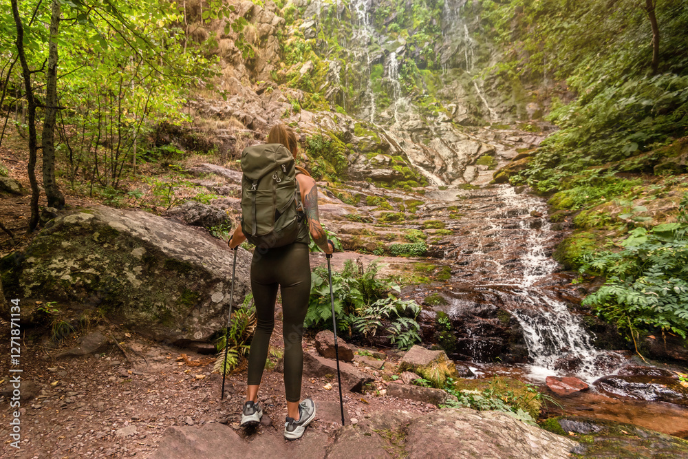 Woman Backpacker Hiking in Mountain Forest with Waterfall