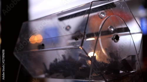 Close-up of the rotation of a transparent lottery reel with lottery tickets