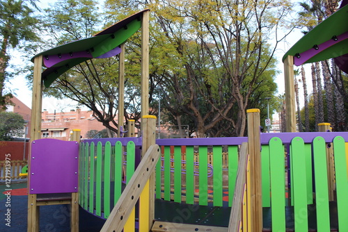 Inclusive playground for children with functional diversity and physical disabilities. Play area with bright and fun colours; there are some bridges.