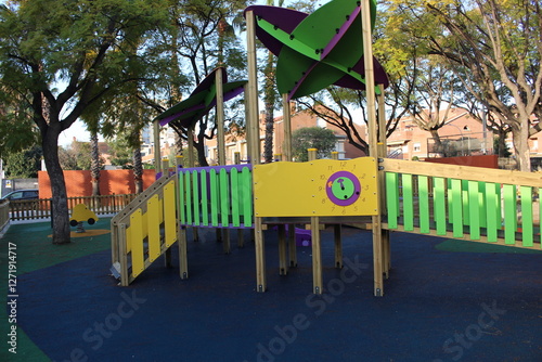 Inclusive playground for children with functional diversity and physical disabilities. Play area with bright and fun colours; there are some bridges.