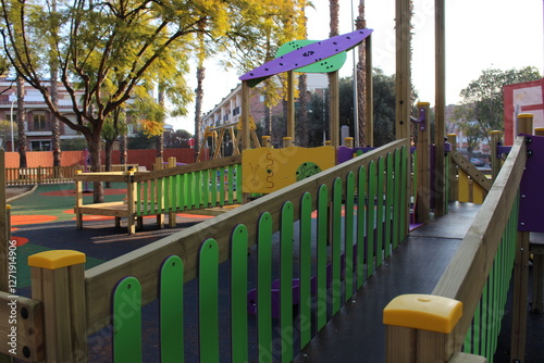 Inclusive playground for children with functional diversity and physical disabilities. Play area with bright and fun colours; there are some bridges.