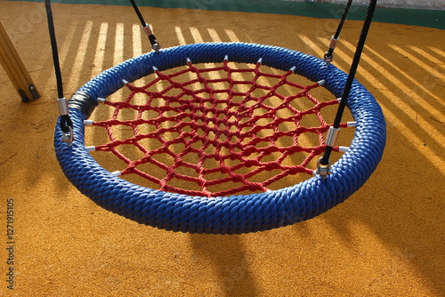 Children's swing adapted for people with physical disabilities. Kids can swing on this park game lying down or stretched out, without having to use any force.