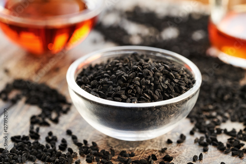 Fototapeta Naklejka Na Ścianę i Meble -  Black cumin or Nigella sativa seed and oil. Nutritional supplement.