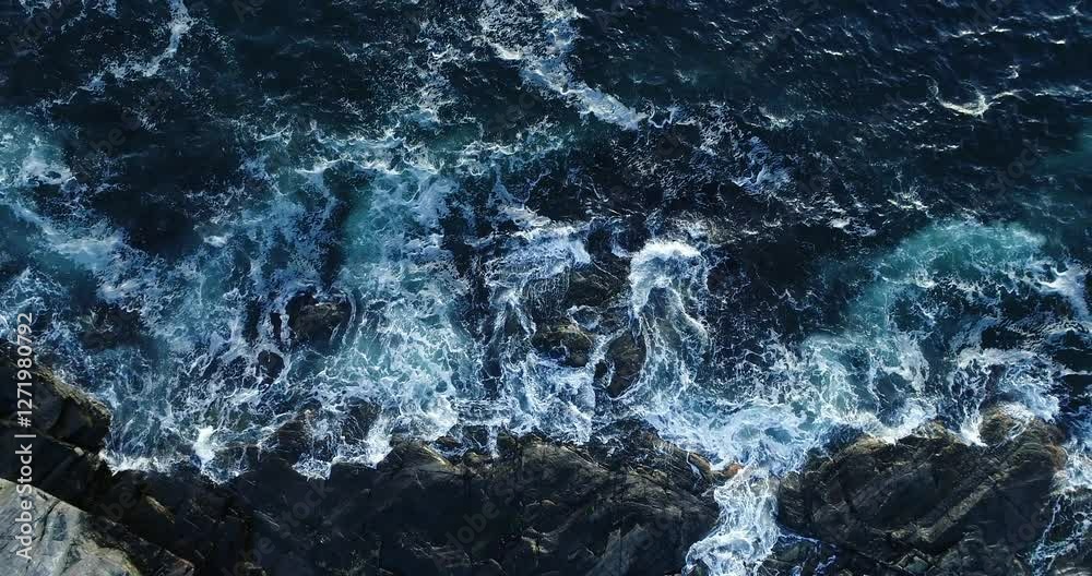 Storm hypnotic powerful waves crashing against rocky coastline in Norway, dramatic ocean scenery, Drone slow-motion footage 4K aerial view