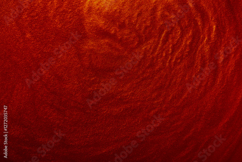 Shimmering red abstract background. Liquid glitter paint texture waves and swirls. Beautiful shiny red glitter texture. Metallic paint close-up as a holiday background.