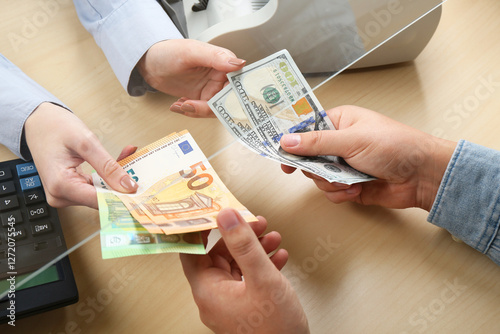 Client exchanging money at wooden table, closeup