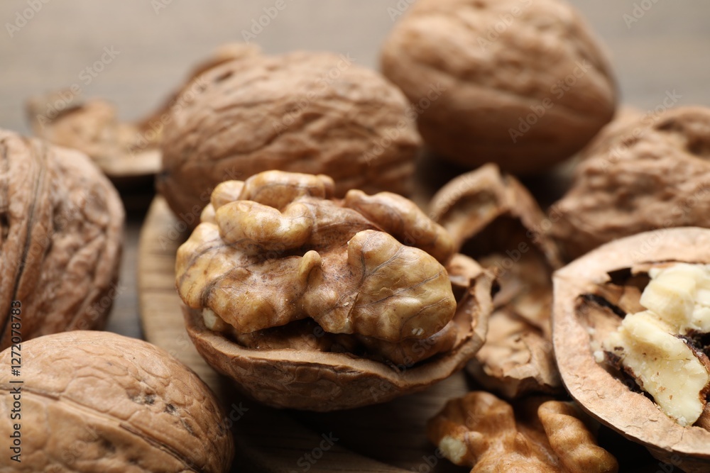 Fresh walnuts with shells on table, closeup