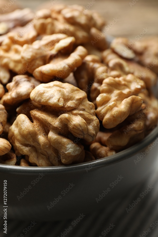 Fresh walnuts in bowl on table, closeup Fresh walnuts in bowl on table, closeup