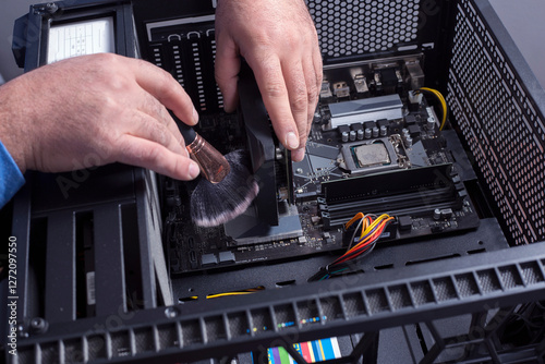 the man cleans the dusty computer