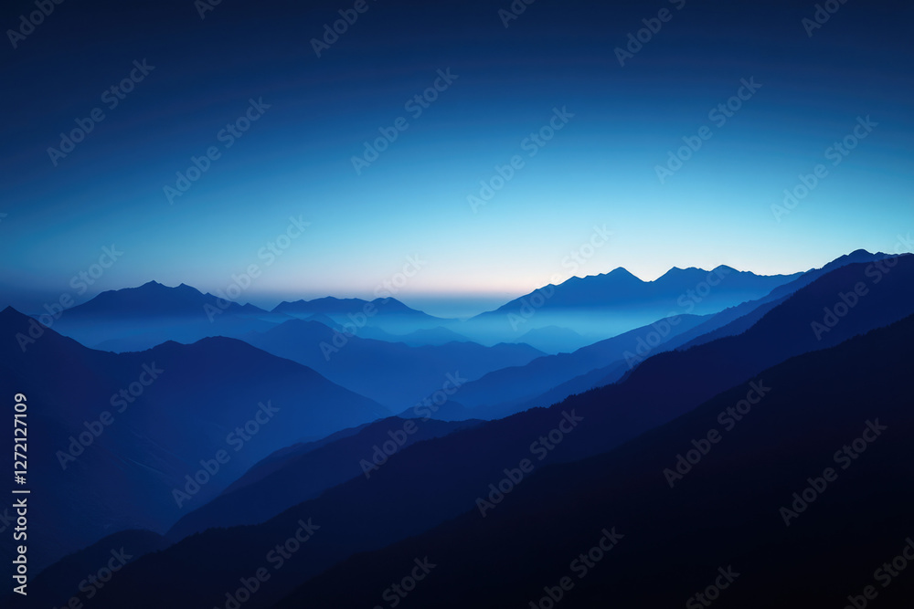 Obraz premium Serene twilight descends upon a majestic mountain range, casting long shadows and a tranquil blue hue.