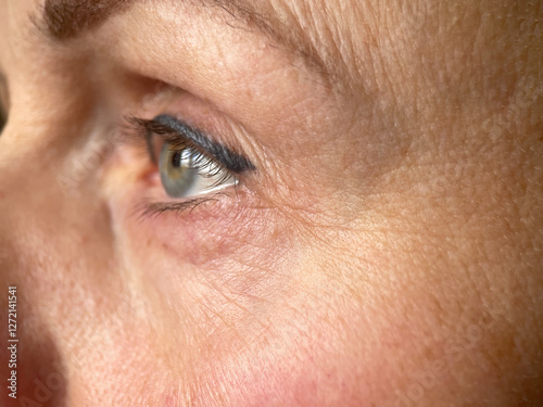 Macro Close-up of an Aging Woman’s Eye with Wrinkles and Natural Skin Texture photo