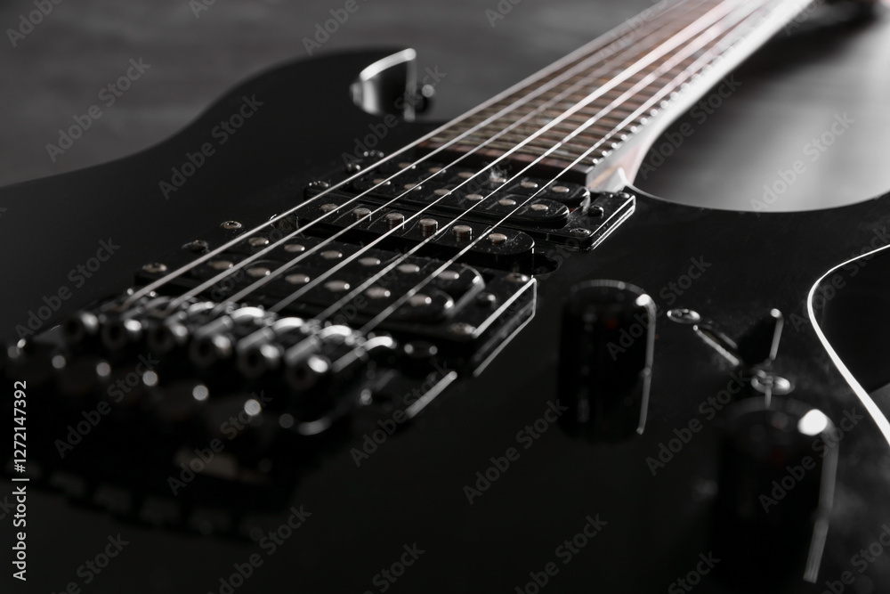 Fototapeta premium Modern electric guitar on black background, closeup