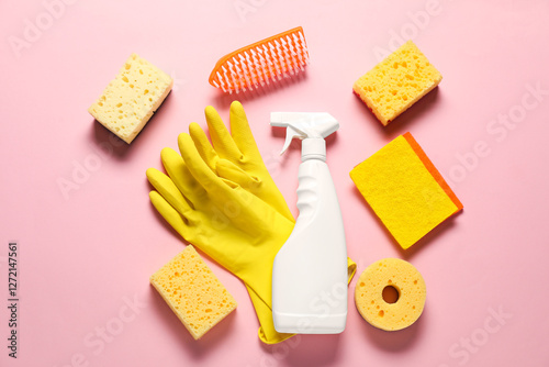 Spray bottle of cleaning product and tools on pink background, flat lay