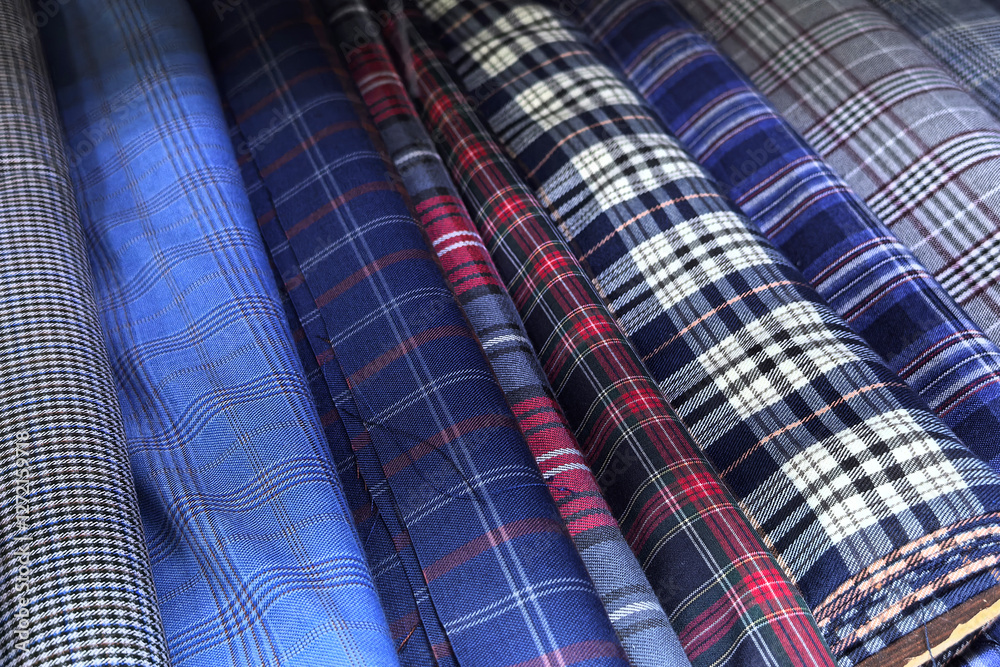 Colorful plaid fabrics arranged in a vibrant display for fashion lovers Colorful plaid fabrics arranged in a vibrant display for fashion lovers