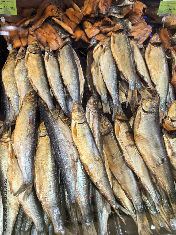 Obraz premium Smoked fish display in a bustling market showcasing vibrant local cuisine