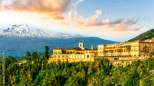 beautiful landscape of Taormina town, Italy, Sicily with scenic view at San Domenico hotel near nice buildings and panoramic view of Etna mountain on background