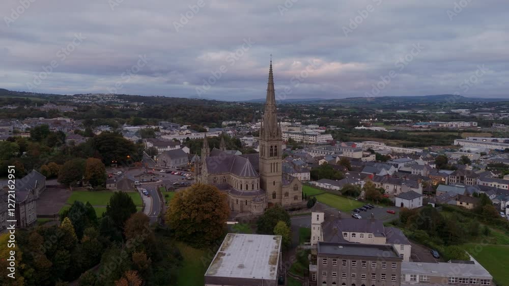 Aerial view over the town of Letterkenny in Ireland in the evening - The urban landscape during sunset showcases vibrant, colorful buildings against a backdrop of a dramatic sky Aerial view over the town of Letterkenny in Ireland in the evening - The urban landscape during sunset showcases vibrant, colorful buildings against a backdrop of a dramatic sky