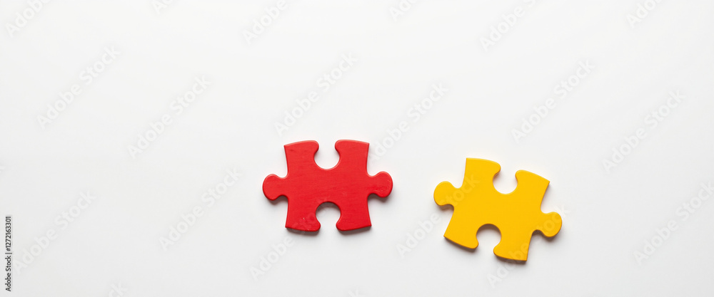 Two colorful puzzle pieces on a clean white background symbolizing connection and unity, evoking feelings of togetherness and harmony in relationships Two colorful puzzle pieces on a clean white background symbolizing connection and unity, evoking feelings of togetherness and harmony in relationships