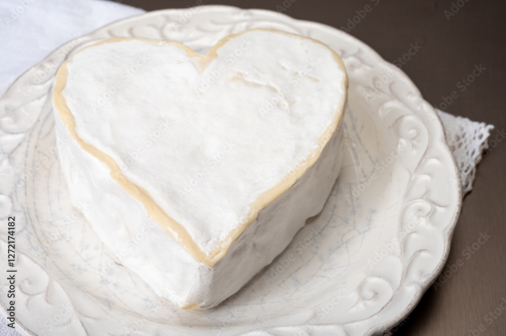 Cheese collection, French cheese from Normandy region, heart-shaped neufchatel from farm shop close up Cheese collection, French cheese from Normandy region, heart-shaped neufchatel from farm shop close up