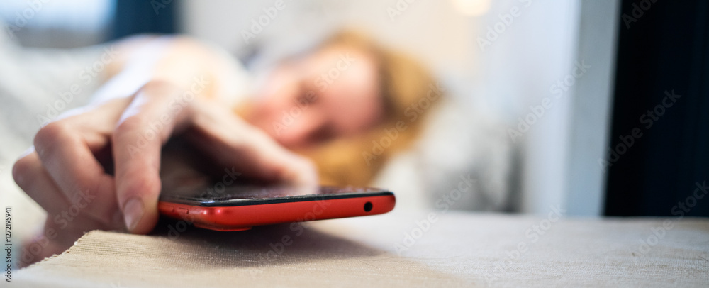 woman using smartphone in bed